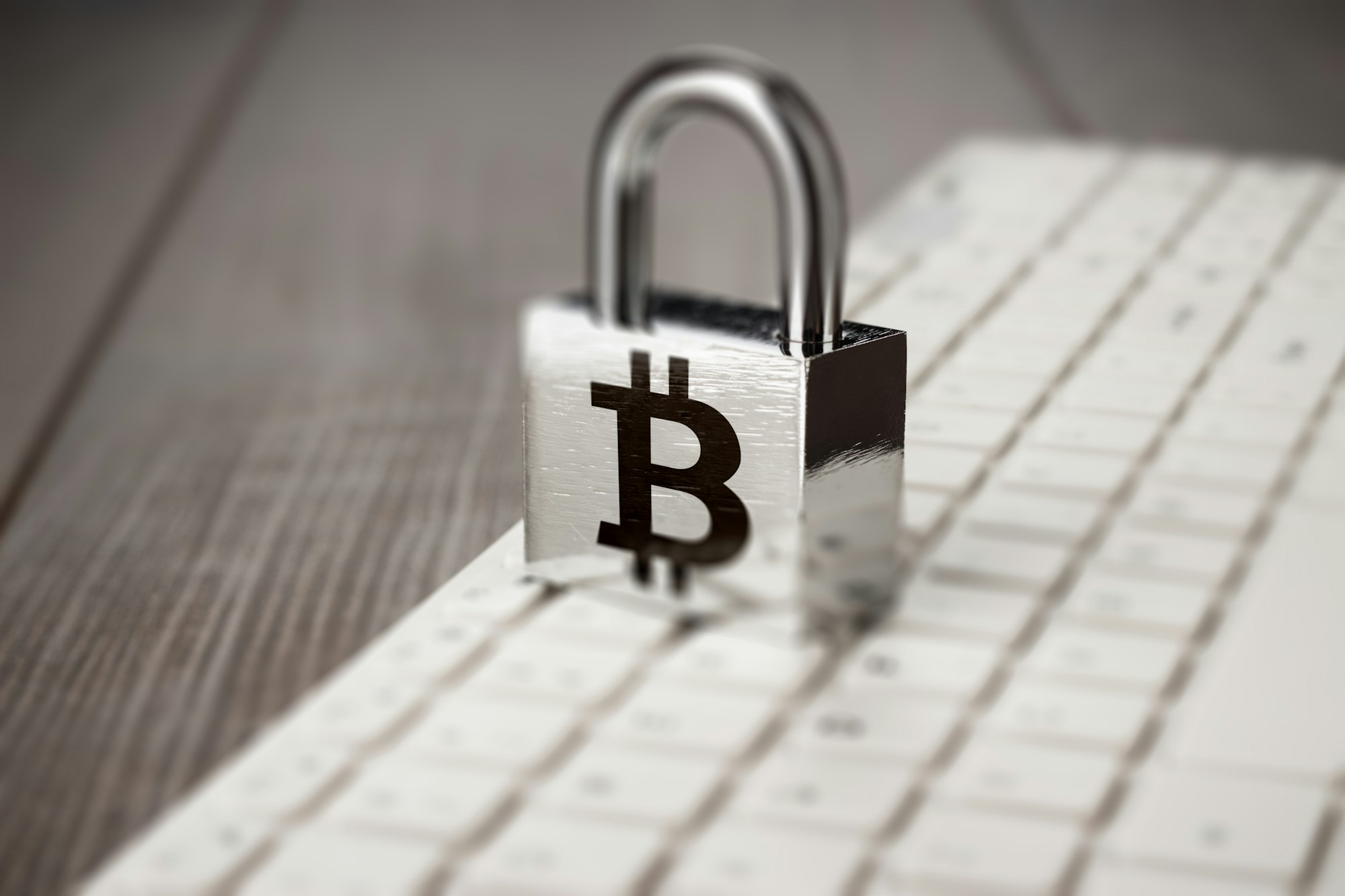Padlock With Bitcoin Symbol On White Computer Keyboard